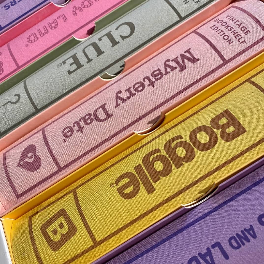 Person sitting at a wooden desk with paper note organizer, pencil and tablet.